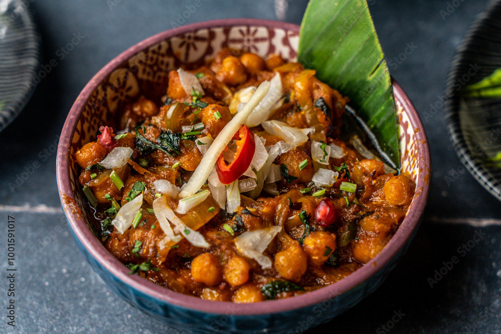 Chana masala (chickpeas) served with spicy red chili and desi masala Chana masala (chickpeas) served with spicy red chili and desi masala