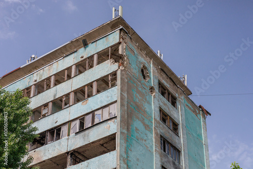 Closeup view of ruined facade of house. photo