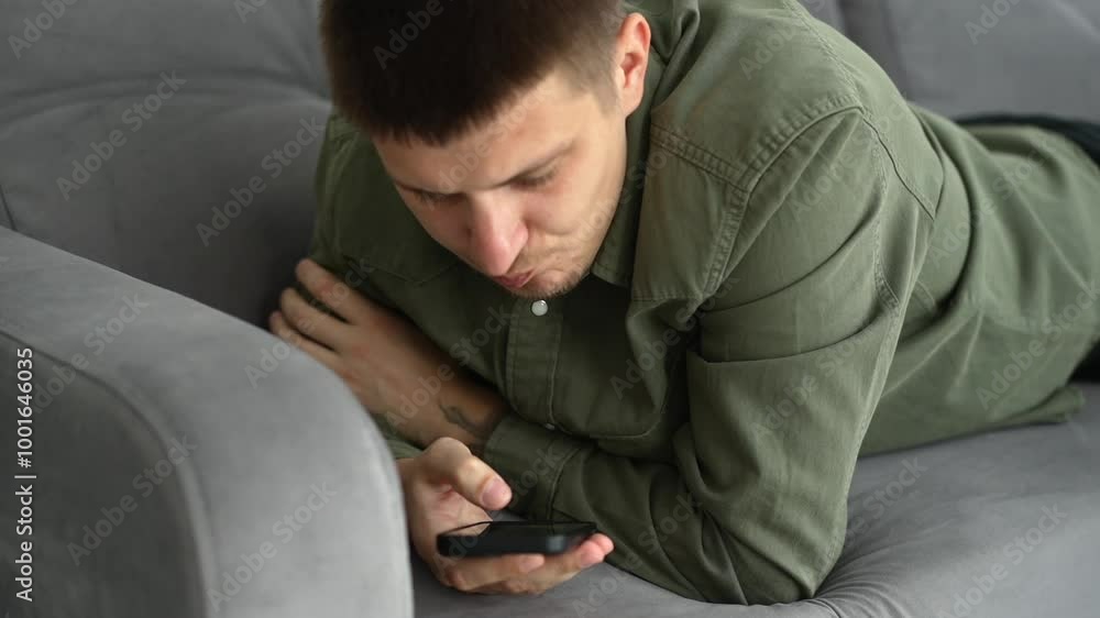 A man lies on the sofa and clicks the phone.
A man with a phone in his hands.
Man on the sofa.
Online shopping.
Internet shopping.
Phone, gadget. smartphone, internet A man lies on the sofa and clicks the phone.
A man with a phone in his hands.
Man on the sofa.
Online shopping.
Internet shopping.
Phone, gadget. smartphone, internet