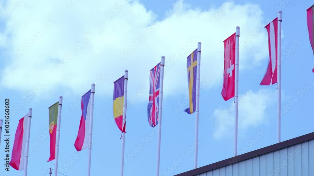 national flags Europe and other countries on satin flutter in wind in blue sky, European Space Agency, state symbols, concept international cooperation, global business