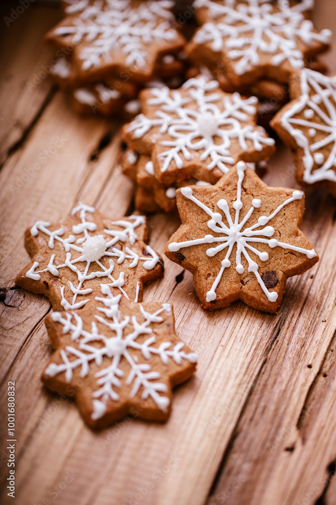 Gingerbread cookies with white snowflake icing, neatly arranged on a rustic wooden surface, evoking a festive, cozy holiday atmosphere perfect for winter celebrations. . Gingerbread cookies with white snowflake icing, neatly arranged on a rustic wooden surface, evoking a festive, cozy holiday atmosphere perfect for winter celebrations. .