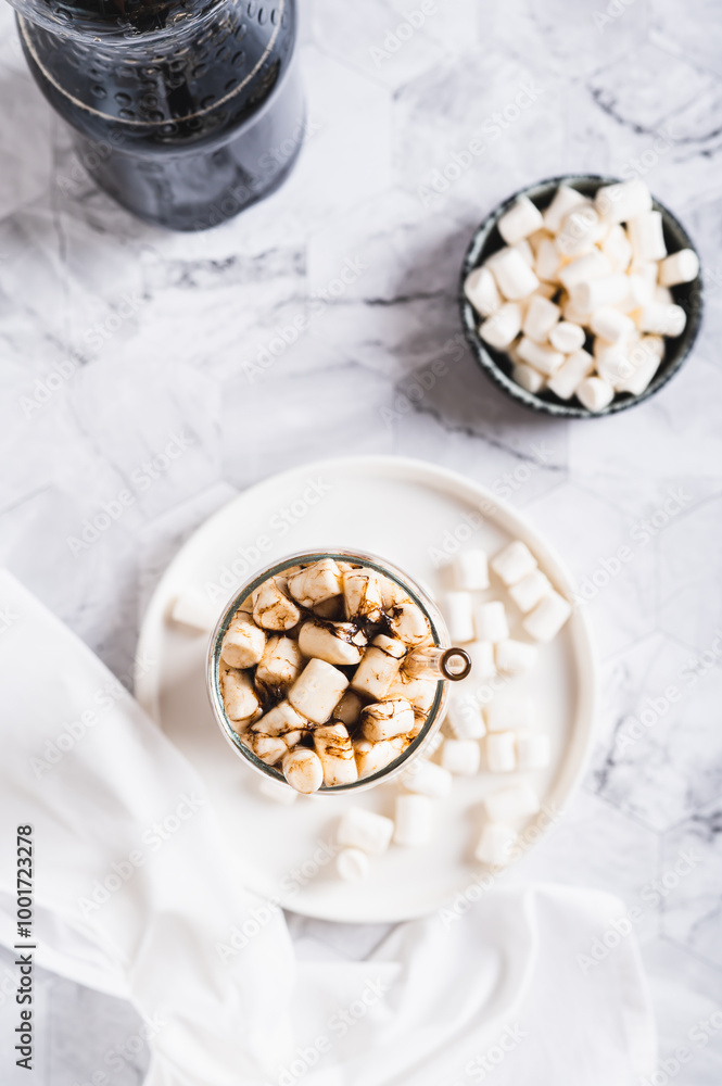 Refreshing fluffy coke with marshmallow in a glass on the table top and vertical view Refreshing fluffy coke with marshmallow in a glass on the table top and vertical view