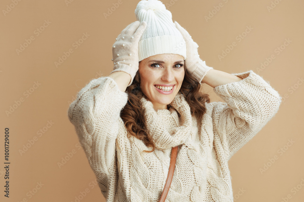 smiling stylish woman in beige sweater, mittens and hat smiling stylish woman in beige sweater, mittens and hat