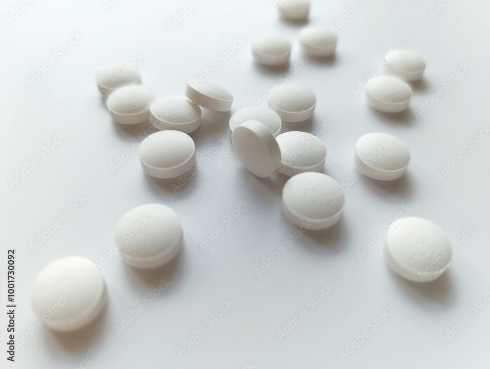 white coal tablets on a gray background
white coal tablets on a gray background