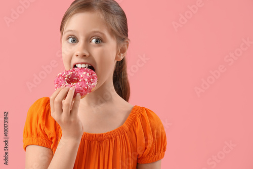 Little girl eating tasty do...