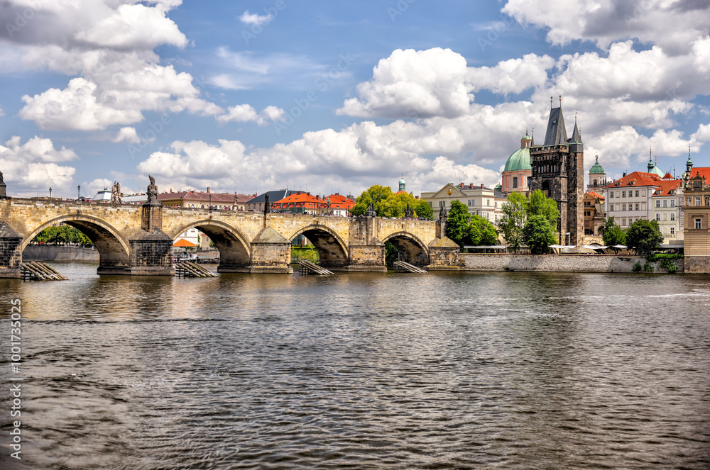 Fototapeta premium Prague, Czech Republic - July 19, 2024: Morning views along the Vltava River and Charles Bridge n Prague in the Czech Republic 