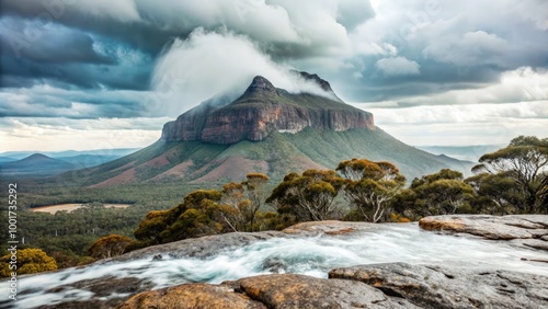 Mount Aigir under rain clouds showcasing dramatic weather and lush surroundings. Generative AI photo