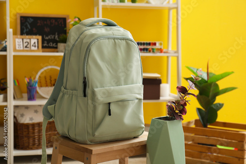 Light green backpack on woo...