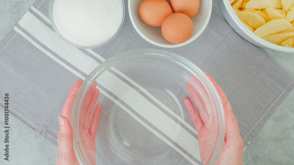 Apple cake recipe. Ingredients for baking needs close-up on a kitchen table, woman hands Apple cake recipe. Ingredients for baking needs close-up on a kitchen table, woman hands