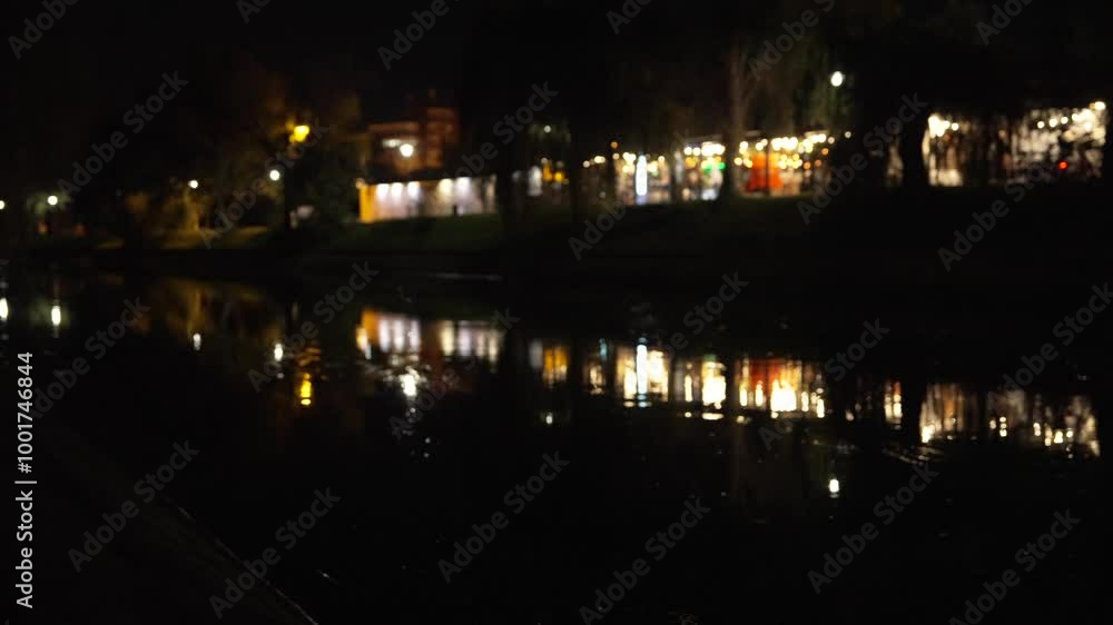 Nocturne reflections of a cosy restaurant in the water of the canal that crosses the entire city, 4k. Nocturne reflections of a cosy restaurant in the water of the canal that crosses the entire city, 4k.