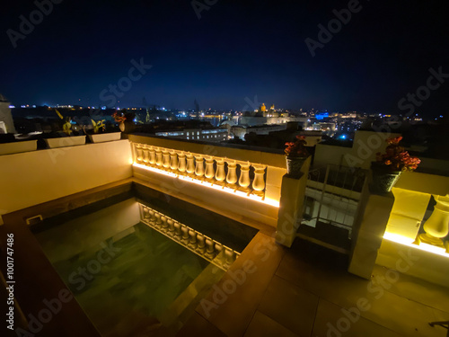 Night scene urban cityscape skyline view in Valletta Malta from a rooftop jacuzzi terrace photo