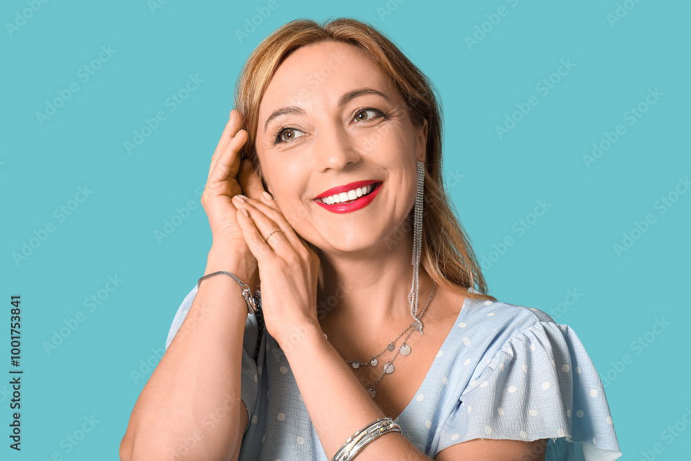 Fototapeta premium Beautiful mature woman with stylish accessories on blue background