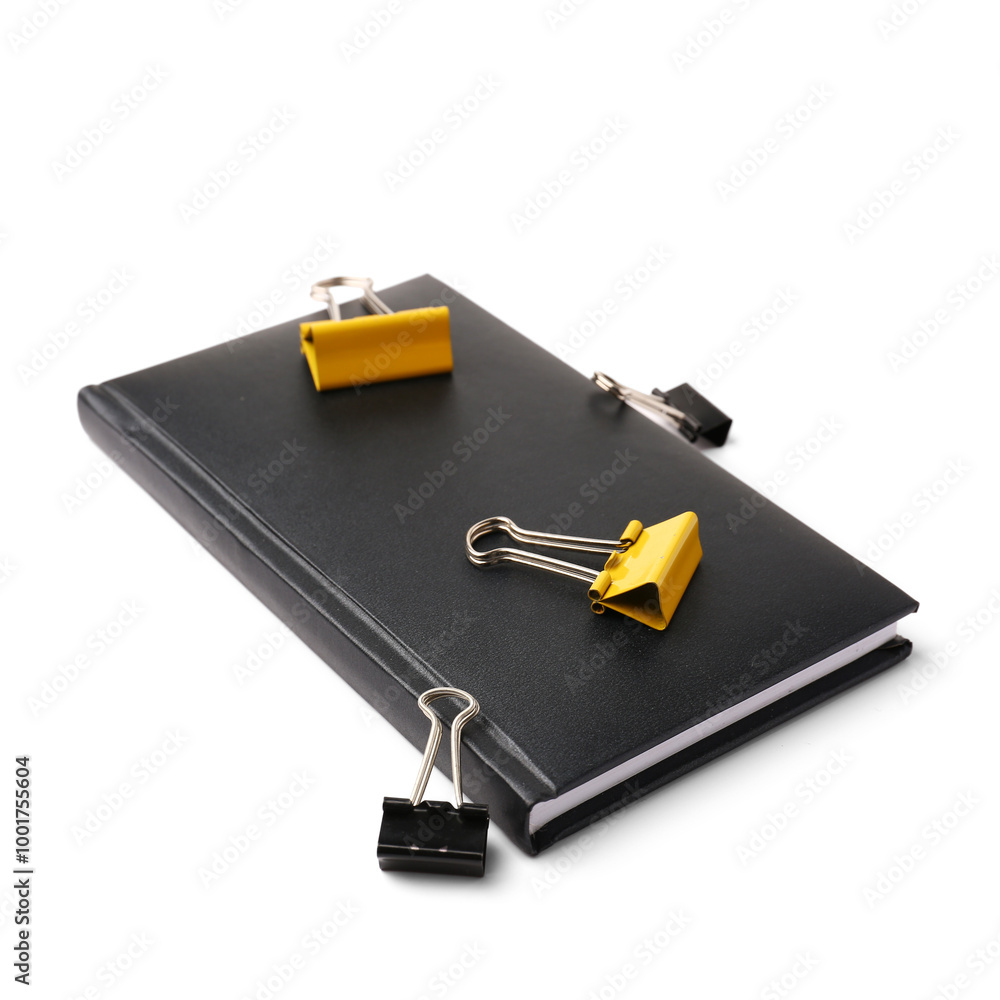 Black notebook and paper clips on white background Black notebook and paper clips on white background