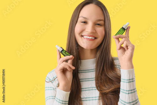 Young woman with bottles of...