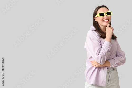Smiling young woman in styl...
