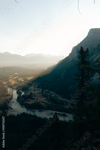 view of a mountain in the shadow in summer with light effect from the sun dancing in the smoke in the air photo