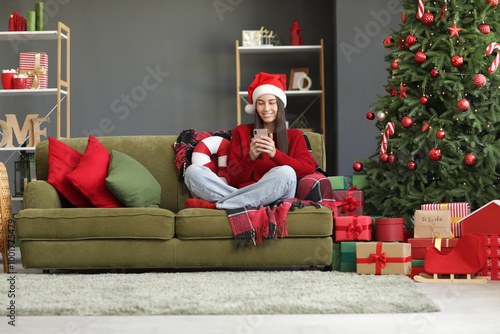 Happy young woman in Santa ...