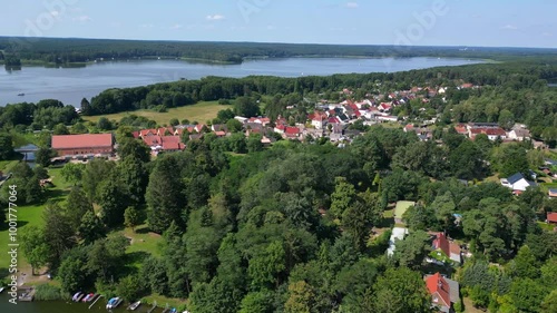 small village at lakes and forests in summer. Smooth aerial view flight drone photo