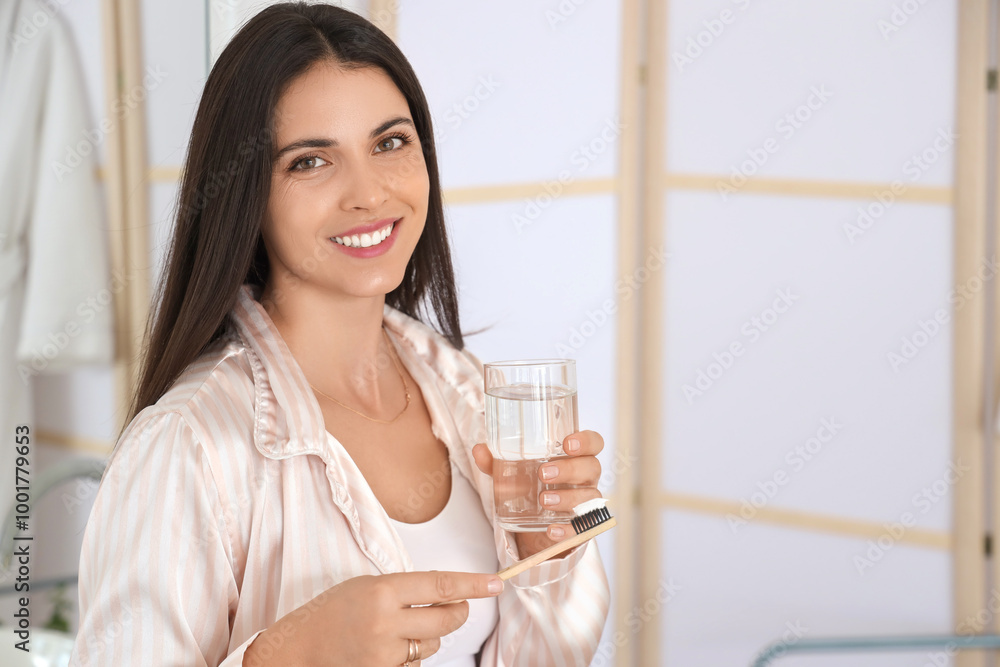 Morning of beautiful woman with toothbrush and glass of water in bathroom Morning of beautiful woman with toothbrush and glass of water in bathroom