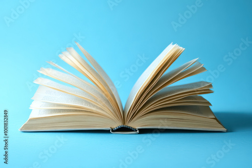 open hardcover book on blue background