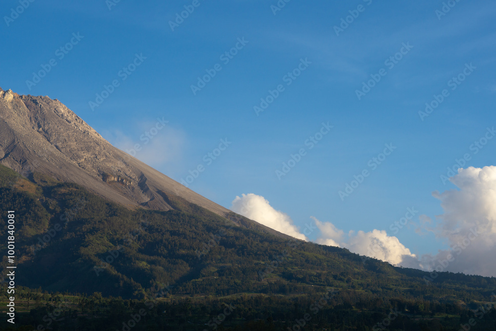 West side valley of Mount Merapi Volcano with clear blue sky in the background viewed from Selo Boyolali, Central Java - Indonesia. West side valley of Mount Merapi Volcano with clear blue sky in the background viewed from Selo Boyolali, Central Java - Indonesia.