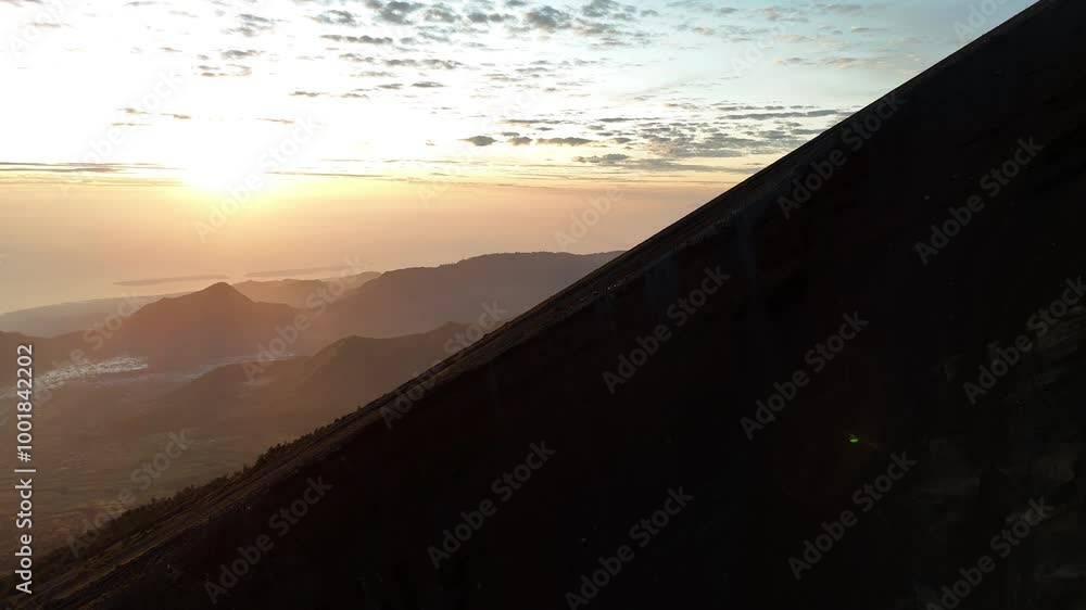 The aerial landscape of the mountain cliff when the sunlight shines brightly, there are climbers climbing The aerial landscape of the mountain cliff when the sunlight shines brightly, there are climbers climbing