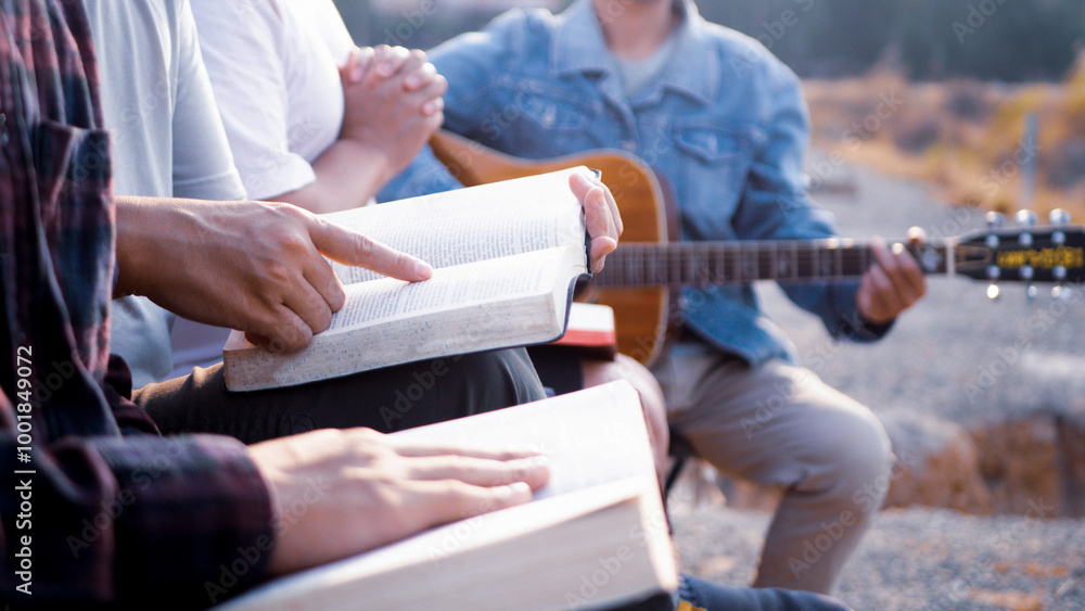Fototapeta premium Bible reading and sharing group, Christians singing hymns, sitting and reading the Bible.
