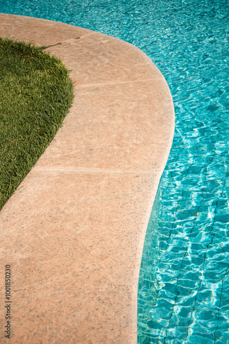 swimming pool with rippled water in sunny day in the summer