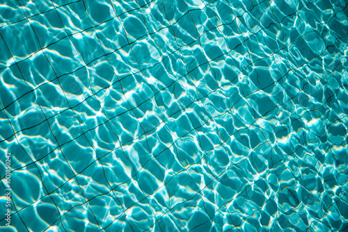 swimming pool with rippled water in sunny day in the summer