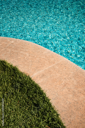 swimming pool with rippled water in sunny day in the summer