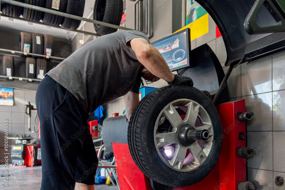 custom made wallpaper toronto digitalCar wheels maintenance. Expert tire repair and replacement at trusted vulcanization point with reliable service. Technical man balancing tires, maintenance and set the wheel center.