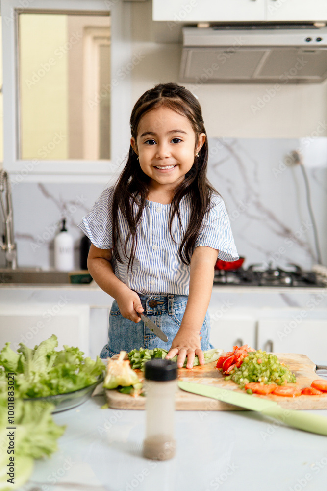 Portrait of little girl making a salad of vegetables. Portrait of little girl making a salad of vegetables.