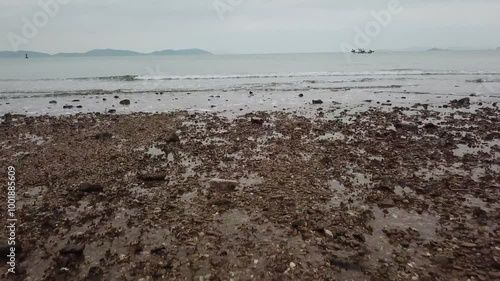 인천 승봉도 자갈이 깔린 해변가에서 바다로 향하는 드론촬영 photo