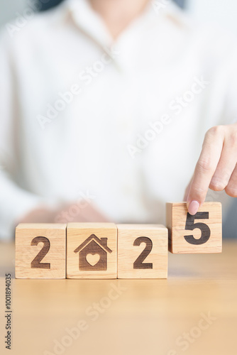 Happy New Year 2025 with Home and Heart block. Property investment, House Mortgage, Real Estate tax, homeless, donation, Financial and happy family concepts