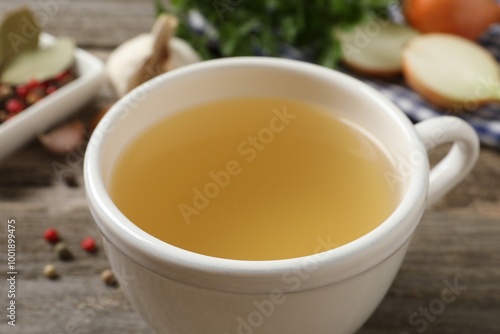 Hot delicious bouillon in cup on table, closeup