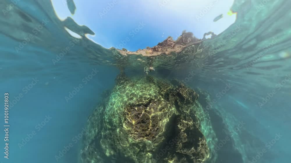 The Man Stands on Top of an Underwater Rock, with the Water and Rock Creating a Small Planet Effect Around Him. The Camera Uses the Hole Planet Effect. The Man Stands on Top of an Underwater Rock, with the Water and Rock Creating a Small Planet Effect Around Him. The Camera Uses the Hole Planet Effect.
