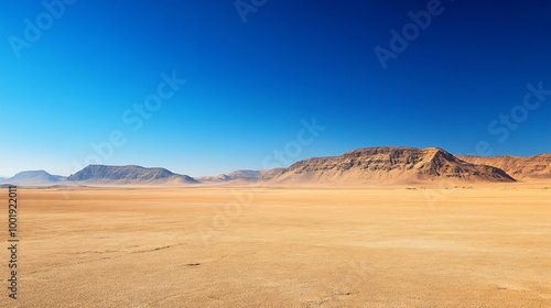 A vast desert landscape under a bright blue sky.