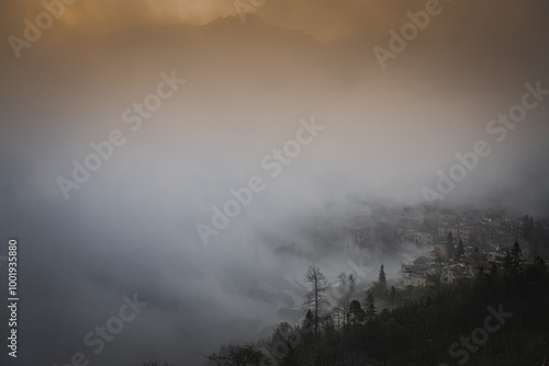 Orange sunrise sky at the rice terraces, dense fog and Duoyishu village, China photo