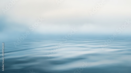 Calm ocean waves in misty morning light