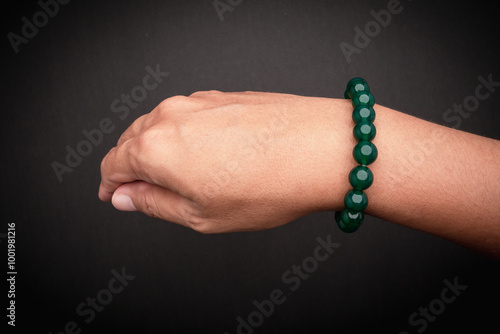 Close-up of green bead bracelet on wrist. photo