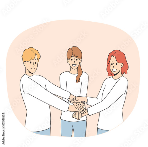 Friendly team of people holding hands demonstrate cohesion and unity, wanting to achieve goals together. Team of young guy and two girls carrying out volunteer or charitable activities