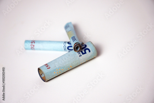 The roll like cigarette of 50 thousand rupiah. 50000 is the second largest banknote denomination in Indonesia. photo