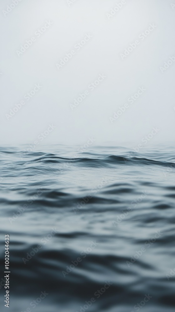 Calm ocean waves under a foggy sky Calm ocean waves under a foggy sky