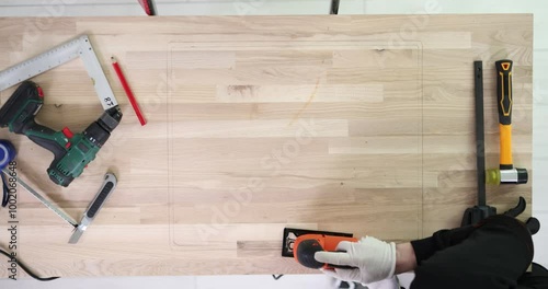 Wallpaper Mural Cutting a rectangular shape from wooden board with electric saw Torontodigital.ca