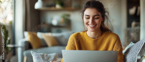 woman smiling while reviewing her work on laptop in cozy living room. warm atmosphere and her joyful expression create sense of comfort and productivity