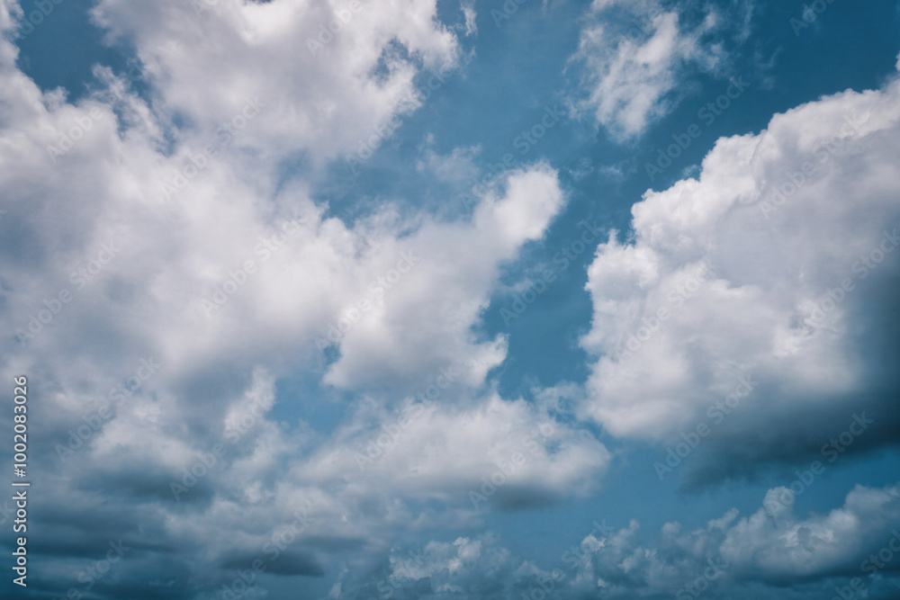 Peaceful Atmosphere: Cumulus Clouds Drifting Through a Radiant Blue Sky. Peaceful Atmosphere: Cumulus Clouds Drifting Through a Radiant Blue Sky.