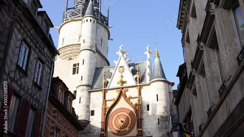 Gothic clock tower in Auxerre, Burgundy, France with traditional houses and blue sky