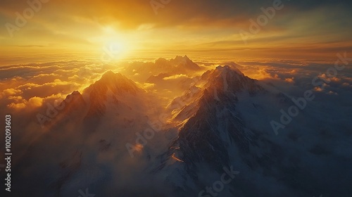 Majestic snow-capped mountain peaks bathed in the golden light of a dramatic sunset.