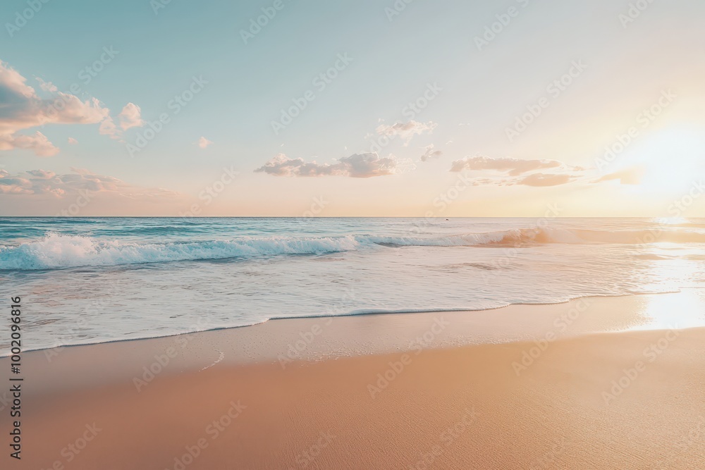 Soft, golden light bathes a sandy beach as the waves gently roll in. Soft, golden light bathes a sandy beach as the waves gently roll in.
