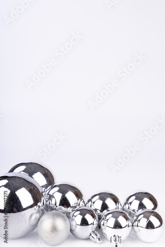 Minimalist display of silver Christmas balls on a white background, offering simple yet festive decoration options photo